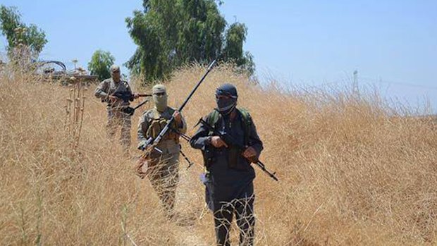 Islamic State militants patrol in Khazer, near Mosul.