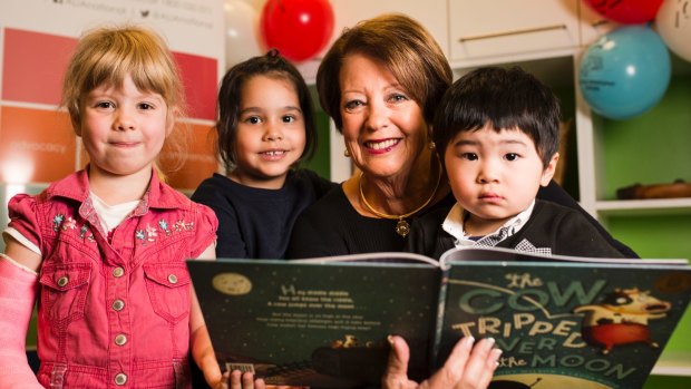 Lady Cosgrove read 'The Cow Tripped Over the Moon' during the 2017 National Simultaneous Story Time. From left, Alice Street 4, Emily Grbic 4, Lady Cosgrove, and Ethan Ng 3.