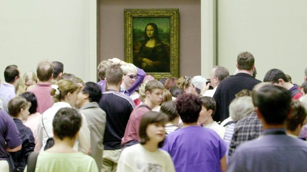 Visitors pack around the Mona Lisa, probably because there was free entry to the Louvre Museum because of a strike.