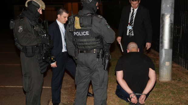 A man is arrested during the drug raids in Sydney.