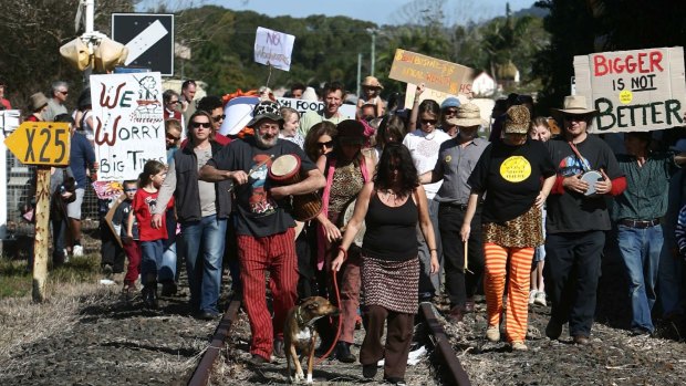 Locals march down the railway track with banners during a protest in Mullumbimby against a proposal to build a Woolworths in town in 2008.