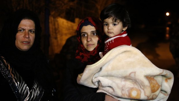 People wait to leave the besieged town of Madaya, north-west of Damascus, Syria. 