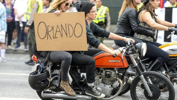 People show their support for the victims of the Orlando mass shooting during the West Hollywood Pride parade on Sunday.