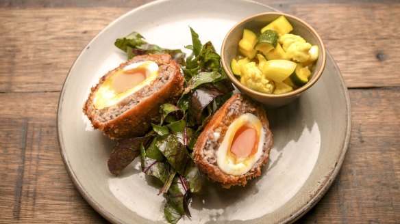 Scotch egg with fresh piccalilli.