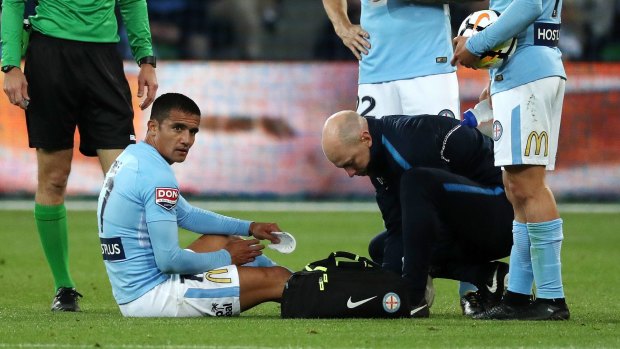 Tim Cahill receives treatment on his ankle injury during Melbourne City's loss to Sydney FC.