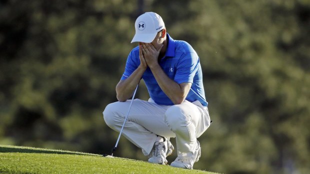 Tough day: Jordan Spieth on the 18th green at Augusta.