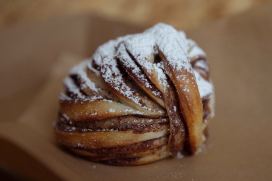 A layered morning bun ready for dipping into coffee.