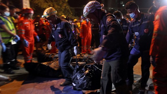 Rescuers carry a body bag after an explosion at a market in Davao City on Friday night.