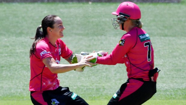 Key wicket: Sarah Coyte and Alyssa Healy celebrate the dismissal of Elyse Villani.