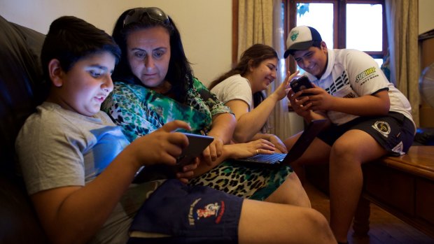 "Bring it on": Mary Boulos with her children (from left), Mikhael, Alyssa and Charvel, looks forward to the day when all the devices in her Hawkesbury home are connected.