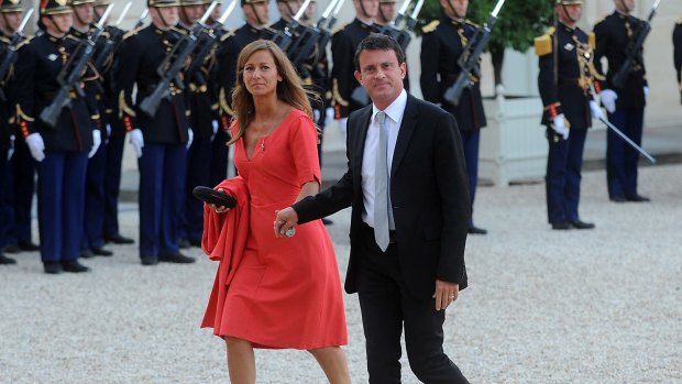 Manuel Valls and his wife Anne Gravoin arrive at the Elysee Palace in Paris in 2013.