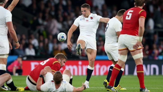 Kicking hell: Sam Burgess kicks the ball during the match against Wales.