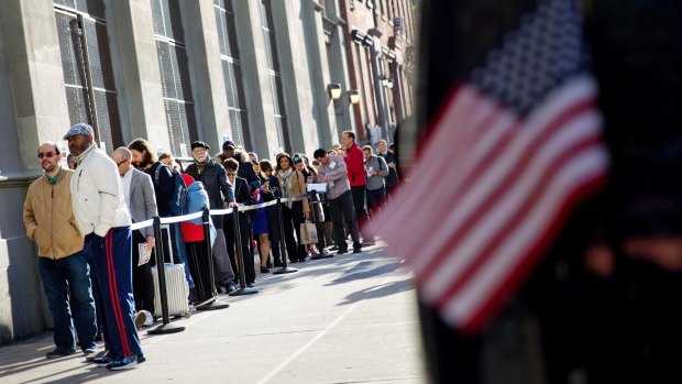 Voters wait their turn in  in the Chelsea neighbourhood of New York.