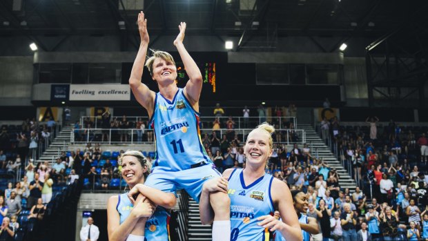 Jess Bibby is carried off by Canberra Capitals teammates Carly Wilson and Abby Bishop after her final WNBL game last season. 
The Canberra Times