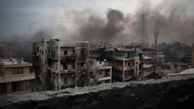 Smoke rises over the Saif al-Dawla district of Aleppo in 2012. 