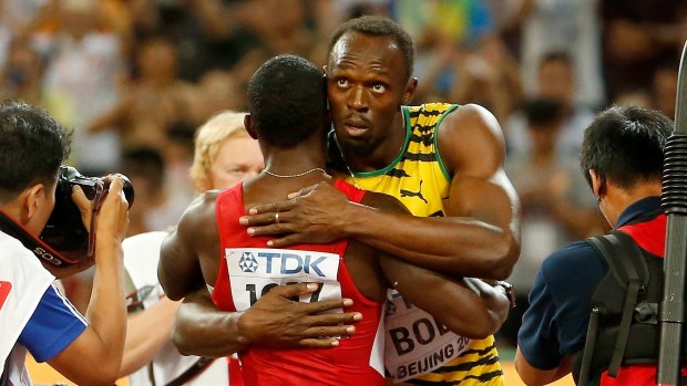 High point: Usain Bolt is congratulated by Justin Gatlin after winning gold in the world 100 metres final.