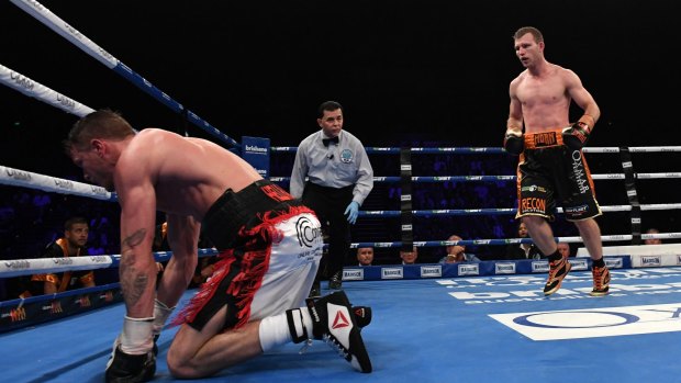 Down but not out yet: Corcoran takes a fall during the WBO world welterweight title fight.
