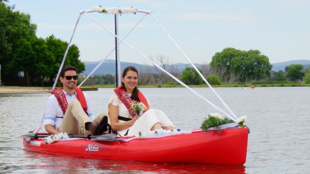 Eder Silva (left) paddled while his bride Aina Studer steered the kayak to their pop-up wedding on Aspen Island.