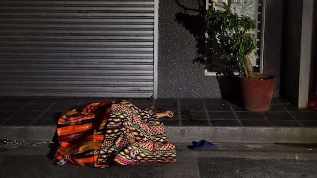 One of two people killed in a double shooting in the Manila suburb of Baclaran, lies in the street. 