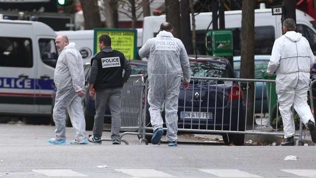 French police gathering evidence at the Bataclan theatre the morning after the terror attacks.