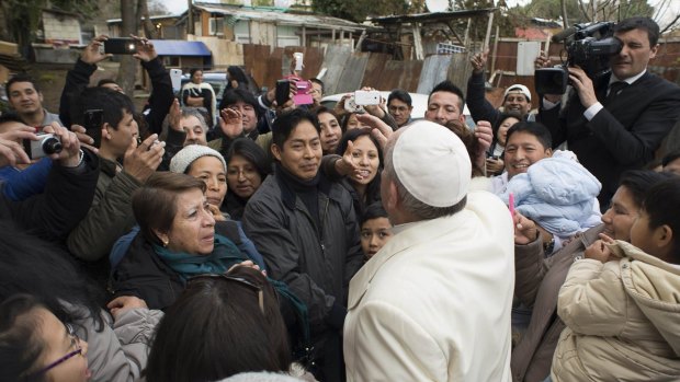 Pope Francis made a surprise visit to a shantytown on Rome's outskirts on Sunday, stunning poor residents, many of them from his native South America.