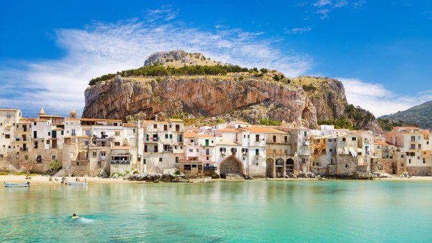 Medieval houses and La Rocca, Cefalu old town, Sicily.