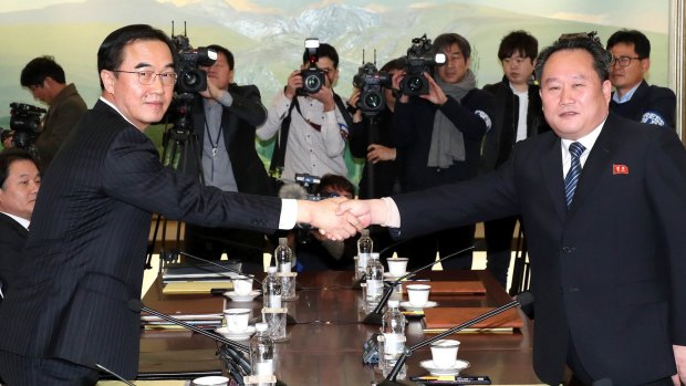 South Korean Unification Minister Cho Myoung-gyon, left, shakes hands with the head of North Korean delegation Ri Son-gwon before their meeting at the Panmunjom in the Demilitarized Zone in Paju, South Korea on Tuesday.