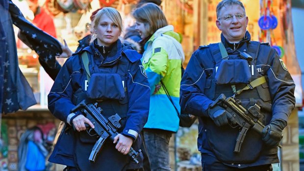 Police officers patrol at the Christmas market in Dortmund, Germany.