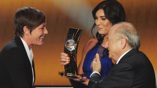 Hope Solo (centre) on stage with Sepp Blatter to present teammate Abby Wambach with the FIFA Women's World Player of the Year award. Solo claims she was assaulted before walking on stage. 