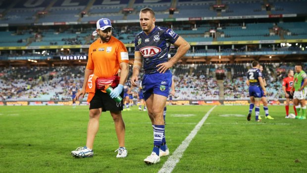 Josh Reynolds of the Bulldogs leaves the field with an injury just before half-time.