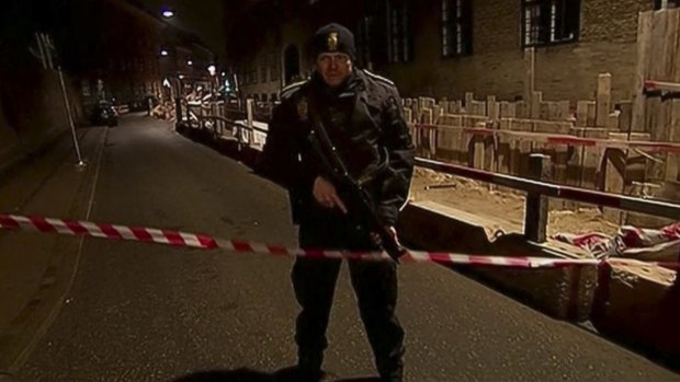 An armed police officer stands guard near the synagogue.