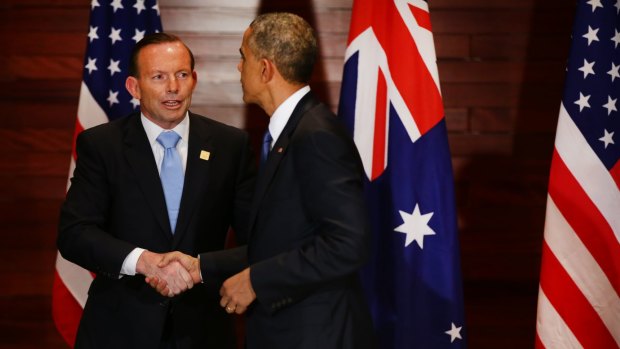 Prime Minister Tony Abbott and US President Barack Obama shake hands after a meeting at the US embassy in Beijing.