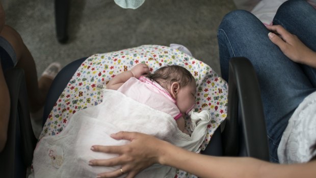 Angelica Pereira waits with baby daughter Luiza at Mestre Vitalino Hospital in Caruaru, Brazil.