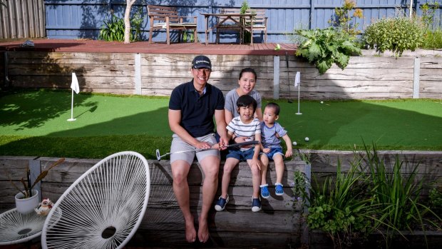 Calan Choke with wife Jan and sons Dylan and Matthew at their backyard putting green. 