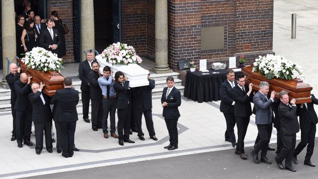 The coffins of Annabelle Falkholt and her parents Lars and Vivian Falkholt are carried out of St Mary's Catholic Church.
