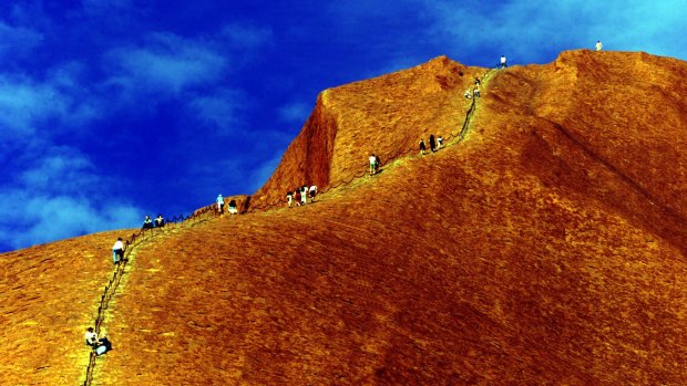 Climbers scale Uluru in the Northern Territory.