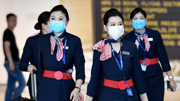 China Eastern Airlines cabin crew are seen wearing protective face masks at Brisbane International Airport.