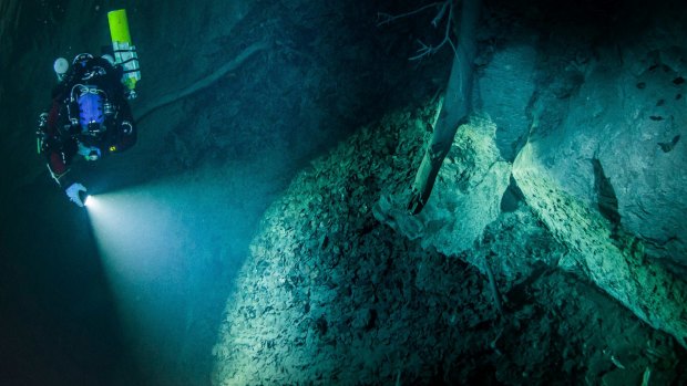Polish explorer Krzysztof Starnawski explores the limestone abyss before a deeper robotic exploration of the flooded Hranicka Propast, or Hranice Abyss, in the Czech Republic.