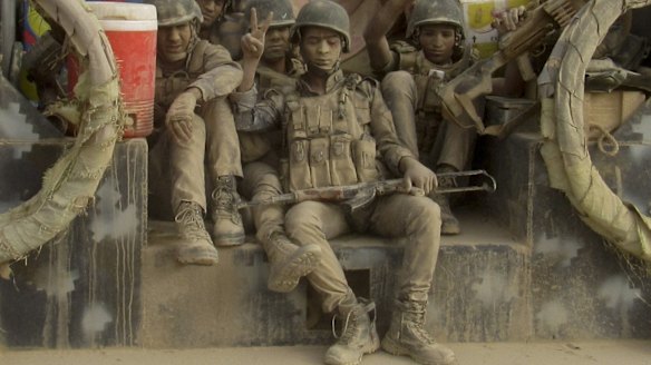 Iraqi Federal police covered in dust arrive to join the forces surrounding Fallujah on Tuesday.