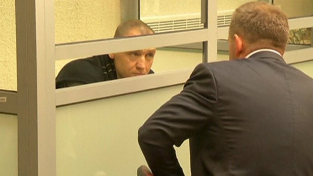 Eston Kohver talks to a lawyer from a defendants' cage during a court hearing in Pskov, Russia.