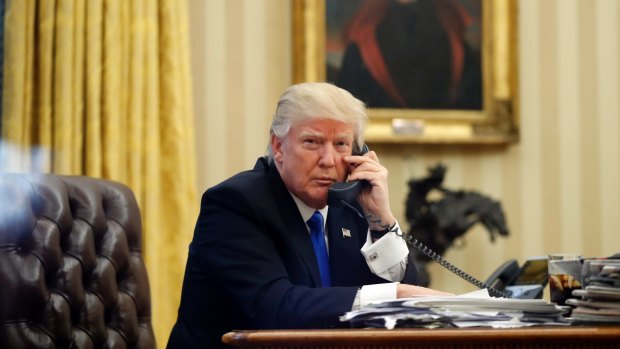President Donald Trump speaks on the phone with Prime Minister of Australia Malcolm Turnbull in the Oval Office of the White House.