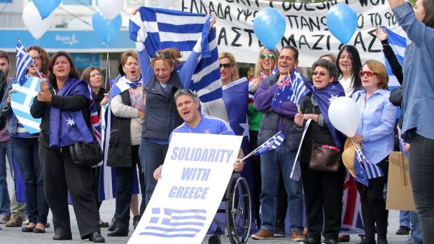 Local Greek community members rally in King George Square.