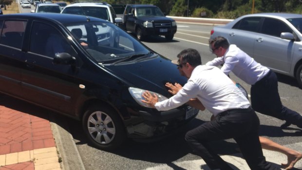 Opposition leader Mark McGowan, with Paul Papalia and Reece Whitby help out a woman in distress after her car broke down.
