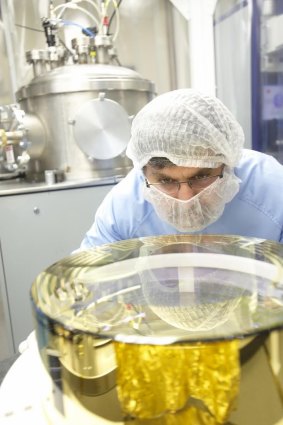 CSIRO technicians work on one of the mirrors to be used in LIGO in the detection of gravitational waves.