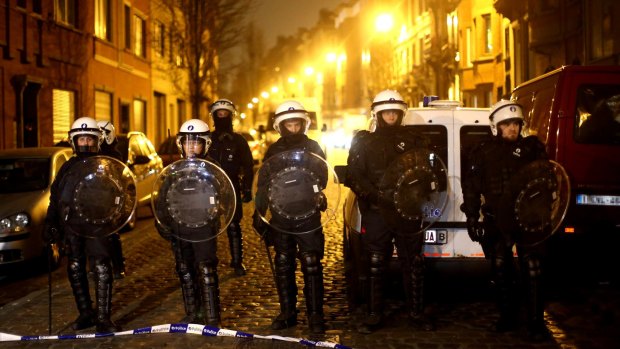 Police officers patrol the streets of Brussels on the weekend after raids in which several people, including Paris attacks suspect Salah Abdeslam, were arrested.