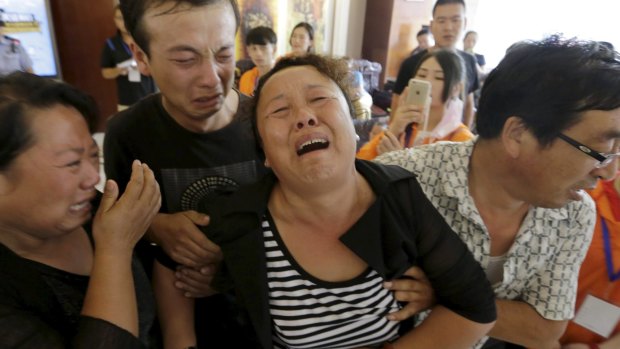A family grieves for missing firefighter Xue Ning.