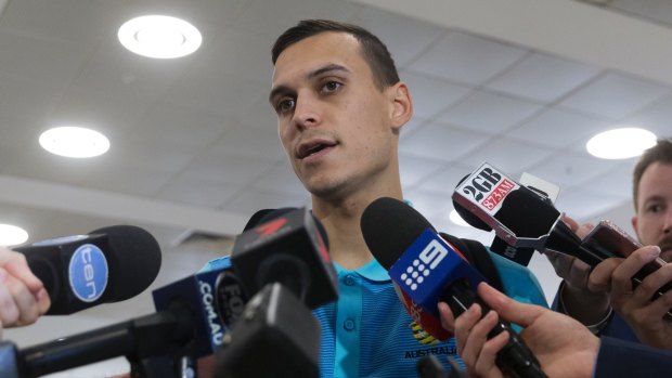 Well travelled: Trent Sainsbury is interviewed after arriving with teamfrom Honduras.