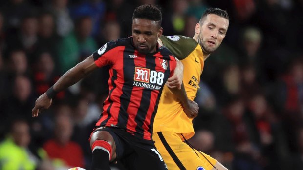 AFC Bournemouth's Jermain Defoe, left, and Brighton & Hove Albion's Shane Duffy vie for the ball.