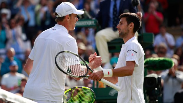Sam Querrey shakes hands with Novak Djokovic after beating the world No.1 in the third round at Wimbledon.