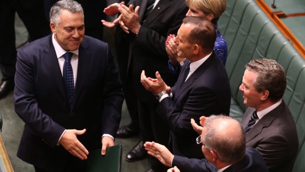 Treasurer Joe Hockey greets his cabinet colleagues as he handed down the Coalition's second budget. 